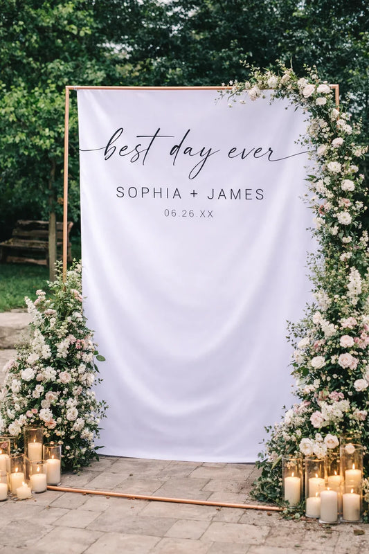 Decorative wedding backdrop with 'best day ever' text, surrounded by flowers and candles.