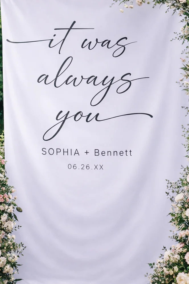Decorative backdrop with floral arches and candles for a wedding ceremony.