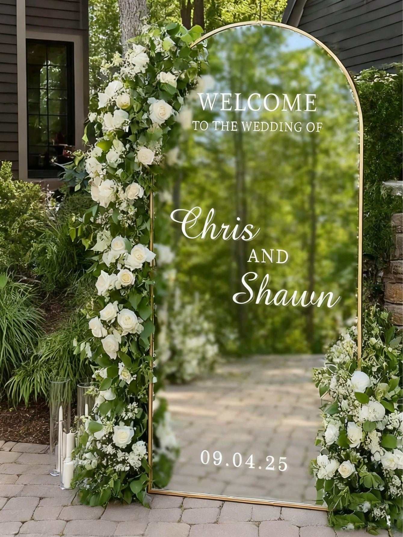 Decorative mirror with floral arch for a wedding entrance, featuring text 'Welcome to the wedding of Chris and Shawn 09.04.
