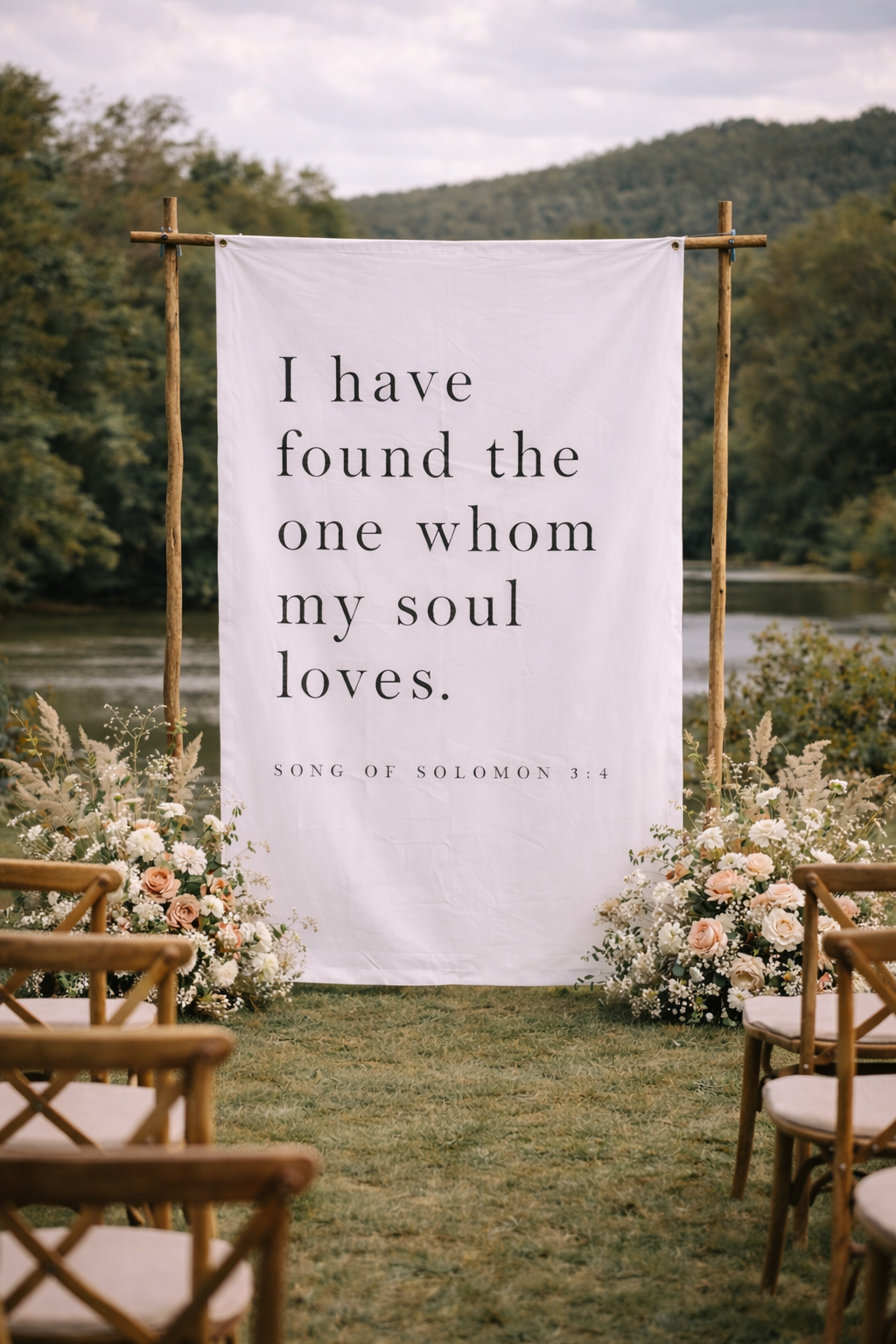 Decorative setup with a banner and floral arrangements outdoors.